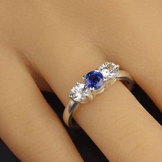 three stone engagement ring with blue and white stones