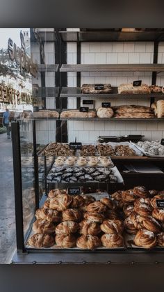 an assortment of baked goods on display in a bakery