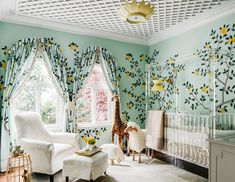 a baby's room decorated in green and white with yellow flowers on the wall