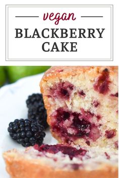 a close up of a piece of cake on a plate with berries and blackberries