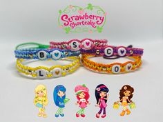 four bracelets with different designs and numbers on them, including one for each girl