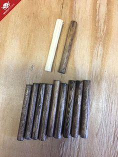 several pieces of wood sitting on top of a wooden table next to a pair of scissors