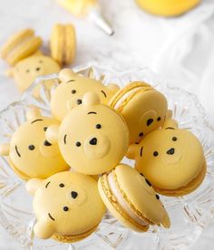 cookies shaped like winnie the pooh are on a glass plate