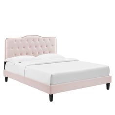 a white bed with pink tufted headboard and foot board on top of it