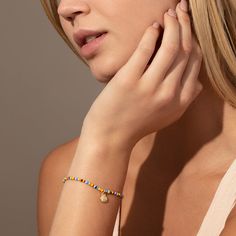 Every summer look needs our Beaded Shell Bracelet. This colorful bracelet features a gold shell charm that’s perfect for every beach trip. For a full look, pair this beaded bracelet with our Beaded Shell Necklace. Gold Beaded Bracelets With Letter Beads For Vacation, Gold Beaded Charm Bracelet For Beach, Casual Gold Stretch Bracelet For Beach, Summer Gold Beaded Bracelets With Letter Beads, Gold Beaded Bracelets For Vacation, Gold Letter Beads Friendship Bracelets For Summer, Gold Bracelets With Round Beads For Vacation, Gold Friendship Bracelets With Letter Beads For Summer, Gold Stretch Bracelet With Colorful Beads For Summer