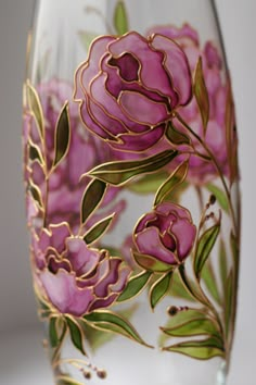 a wine glass with flowers painted on it