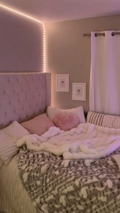 a bed with white and pink blankets on it