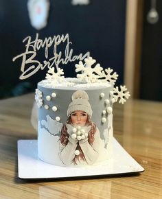 a birthday cake with an image of a woman on it and the words happy birthday written in arabic