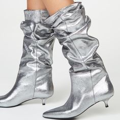 Discover the epitome of chic with our silver kitten-heel slouch boots. These boots boast a trendy kitten heel and a pointed-toe design, exuding elegance and style. The comfortable kitten heel ensures you can confidently wear them all day or night. With their eye-catching silver finish and convenient mid-calf length, these boots effortlessly elevate any outfit. Handcrafted US sizing. Fits true to size. Heel height: 2" / 50 mm approx Product measurements were taken using size 8. Please note that m Silver Kitten Heels, Clear Boots, Kitten Heel Boots, Slouch Boots, Cute Birthday Outfits, Trending Boots, Slouched Boots, Comfortable Boots, Calf Boots