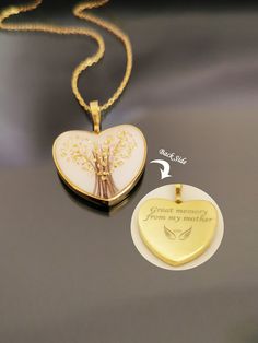 a heart shaped locke with a tree on it and a tag attached to the necklace