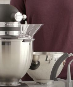 a person standing in front of a mixer