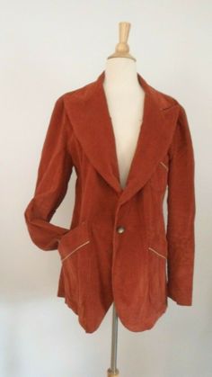 Vintage Suit Coat Jacket 1970's Vintage Corduroy Blazer No maker tag 70's Popular Rust Colored Super Wide Lapels Pleated Back Pockets have Sewn Pleats and Tan Trim The size is a 44, but Please go by measurements taken laid flat seam to seam 18' shoulder to shoulder 22 3/4" armpit to armpit 25 3/4" sleeves from shoulder 30 1/4' long from back neck Great Vintage Condition. A small spot on the front near the single button Vintage items are Unique and Often one of a Kind. No fear of seeing a carbon Disco Jacket, Vintage Suit, Tan Trim, Vintage Corduroy, Flat Seam, Suit Coat, Vintage Suits, Corduroy Blazer, Suits Coats