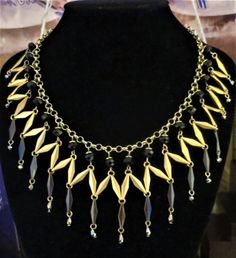 A striking vintage bib necklace comprising black and gold metal links with French Jet accents 16 inches in length but extends to 19 inches Lobster claw fastening Good vintage condition Vintage Black Metal Chain Necklace, Gold Choker With Black Beads For Parties, Black Metal Costume Jewelry Necklace, Vintage Black Brass Necklace, Vintage Black Chain Necklace With Adjustable Chain, Vintage Black Chain Necklace For Party, Vintage Metal Necklace With Black Beads, Vintage Dachshund, Bead Bar