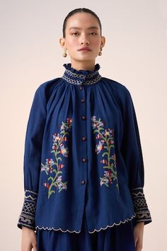 Blue top with pixel embroidered floral vine motifs, scalloped hem and smocked details. - Aza Fashions Blue Cotton Blouse With Smocked Cuffs, Floral Embroidered Smocked Top For Spring, Spring Floral Embroidered Smocked Top, Blue Bohemian Smocked Top For Spring, Bohemian Blue Smocked Top For Spring, Embroidered Cotton Smocked Top For Summer, Casual Embroidered Smocked Top, Traditional Summer Tops With Embroidered Cuffs, Indigo Cotton Top With Floral Embroidery