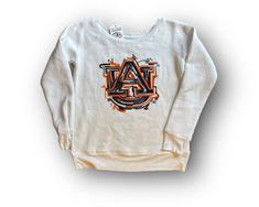 Justin Patten brings his unique, artistic style to Auburn with his exclusive Auburn University licensed apparel. His artwork is printed on a high-end women's fleece crew neck. The neck line is sized to give you the off the shoulder look. Sizing:This fits true to size, but size up to give yourself the relaxed off the shoulder look. Fabrication:52% Airlume combed and ring-spun cotton, 48% polyColor:White Justin Patten is Licensed by Auburn University to create this crew. © Justin Patten. All right Casual Crew Neck Sweatshirt With Custom Artwork, White Sweatshirt With Sublimation Print For Fall, University Sweatshirts, Auburn University, Artistic Style, Auburn Tigers, Womens Fleece, Corsets, Auburn