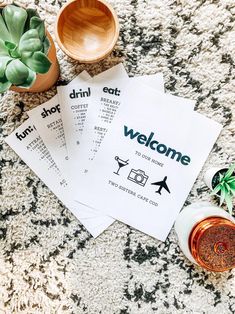 three menus sitting on top of a carpet next to some plants