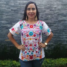 This feminine vintage style shirt is beautifully made. Black with colorful flowers, it is a unique one of a kind. It is shown with a belt as an example of how you might want to wear it. Since it is hand embroidered, each flower is slightly different. It is made of cotton and it extremely comfortable. About Our Items: Each one of our items are handmade/hand woven by Indigenous communities of Chiapas and Oaxaca in Mexico. Great care has been taken to ensure the quality of uniqueness of each item w Traditional Crew Neck Top For Festivals, Traditional Short Sleeve Printed Blouse, Traditional Printed Shirt For Festivals, Traditional Multicolor Printed Shirt, Traditional Multicolor Embroidered Shirt For Summer, Cotton Floral Print Blouse For Festival, White Bohemian Embroidered Shirt, Traditional Short Sleeve Tops With Motif, Traditional Shirt With Multicolor Embroidery For Summer