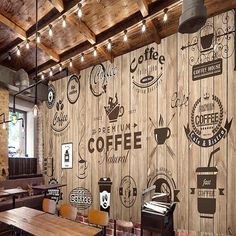 a coffee shop with wood paneled walls and wooden tables in front of the wall