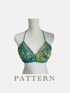 a woman's bra top with crochet and beads on the bottom, in green