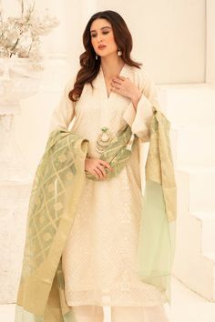 Illuminate your wardrobe with our expertly crafted White and Green Shalwar Kameez. Made with luxurious khaadi silk, intricately embroidered with motifs and embellished with dabka and beads for a touch of elegance. Complete your look with our jamawar organza mint green dupatta for a perfect finish. Perfect for formal events and special occasions. Semi-stitched Raw Silk Kurta With Dabka Work, Semi-stitched Chanderi Sharara With Dabka, Semi-stitched Cream Kurta With Zari Work, Formal Chanderi Dupatta With Naqshi Detailing, Formal Naqshi Chanderi Dupatta, Designer Silk Salwar Kameez With Zari Work, Transitional Silk Kurta With Dabka Detailing, Semi-stitched Dola Silk Sharara With Naqshi Details, Semi-stitched Dola Silk Sharara With Naqshi