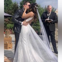 a bride and groom kiss as they are married