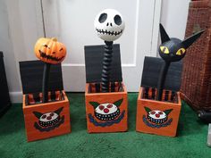 three wooden boxes with halloween decorations on them