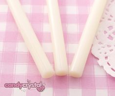 10 x Milky white mini glue gun glue sticks  http://candy-crystal.co.uk/diy-deco-supplies/deco-sauces-glues/10-x-milky-white-deco-sauce-decoden-hot-melt-glue-sticks-7-5mm-10cm.html  SKU: 1071 Milky White, Beauty