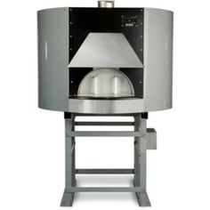 a large metal object sitting on top of a white floor next to a stand with an oven in it