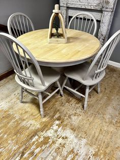 a wooden table with four chairs around it