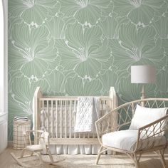 a baby's room with green and white wallpaper