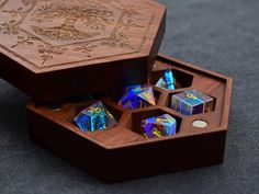 a wooden box filled with assorted dices on top of a carpeted floor