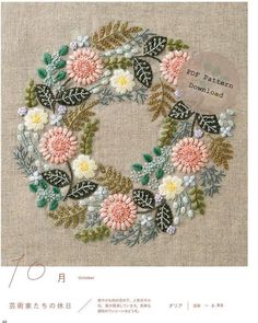 an embroidered wreath with flowers and leaves on it