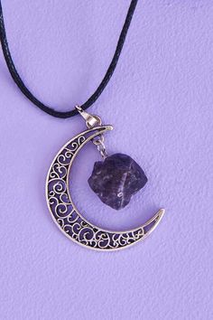 Protect your energy and radiate moon magic in this adjustable necklace that features a lobster clasp claw, nugget of genuine amethyst stone, and an intricately designed crescent moon pendant. Amethyst helps to ward off negative influences and protect from environmental stress. It also works with the third eye and crown chakras to enhance spiritual awareness. Moon Phases Bracelet, Amethyst Pendulum, Oval Amethyst Ring, Amethyst Wand, Balance Bracelet, Caged Necklace, Amethyst Tumbled, Amethyst Studs, Crescent Moon Pendant