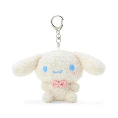 a white stuffed animal keychain with a pink bow tie on it's neck