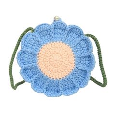 a crocheted bag with a blue flower on the front and green string around it