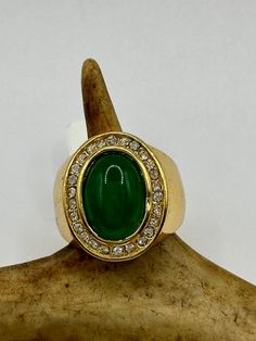 vintage green fun jade ring  Setting is a golden finished bronze setting  This is one of my hand re finished treasures. Salvaged from vintage.  Size   8.75 Re sizing can be done for a $20 fee and may take up to a week.  Engraving is $4 per letter.  Thank you for supporting a veteran's small business. All jewelry is shipped free within the US in a stylish gift box Vintage Gold Emerald Cabochon Ring, Vintage Emerald Cabochon Ring Collectible, Vintage Oval Jade Emerald Ring, Vintage Round Jade Rings, Retro Green Ring As Gift, Retro Green Ring For Gift, Vintage Jade Rings For Formal Occasions, Vintage Green Rings With Stone Setting, Vintage Gold Emerald Ring For Collectors