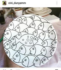 a plate that has been decorated with fish on it