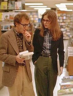 two people standing in a store looking at books