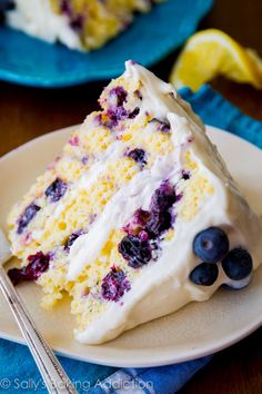 a slice of lemon blueberry cake on a plate with a fork next to it