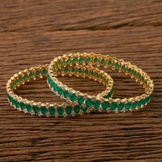 Gorgeous high-end emerald and CZ Bangles ( sold in pair) This pair looks elegant at first glance. Due to the minimalist design of this jewelry piece, you can easily pair it with dresses, sarees, casual tank tops, and kurtis. Style guide: This bangle is something that you put on and then never take it off. It pairs fantastically with formals and casuals, adding a zing to them, and just a touch of glimmer! Highest quality and craftsmanship, Ready to ship from Edison NJ USA To measure the size of t Emerald Diamond Bangles, Kurtis Style, Sarees Casual, Cz Bangles, Indian Bangles, Indian Bridal Photos, Diamond Bangles, Indian Necklace, Bangles Indian