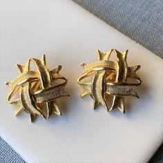 "Vintage gold tone crisscross style clip on earrings. These vintage beauties likely date to the 1980s - the yellow gold color looks like the real thing! Domed, double crisscross style earrings in excellent condition. They are unmarked and measure 1 1/8\" diameter. Measurements: Approximately 1 1/8\" diameter Condition: Excellent - no noticeable wear. Markings: None" Vintage Gold Clip-on Earrings As Gift, Vintage Gold Clip-on Earrings, Vintage Gold Clip-on Hoop Earrings, Gold Vintage Metal Clip-on Earrings, Vintage Gold Plated Clip-on Earrings, Clover Earrings, Silver Plated Jewelry, Pretty Earrings, Vintage Rhinestone