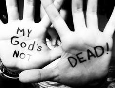 two hands with writing on their palms and the words my god is dead written on them