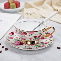 a tea cup and saucer with a spoon in it