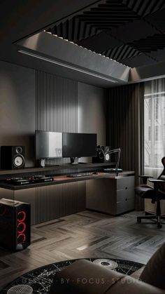 a room that has some speakers and a desk in it with a computer on it