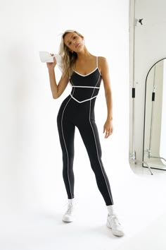 The versatile bodysuit to put on repeat. The Breathe Bodysuit was thoughtfully designed with a figure-flattering geometric outline detail in our thick, squat-proof fabric. Figure flattering white line details across bust, body, and legs NOT recommended for those larger than a B cup, due to potential cleavage NOT recommended for long torsos V-cut sweetheart neckline with horizontal cutout around back Dainty straps Neutral black coloring Form flattering bodysuit fit with removable pad inserts Inseam measurements: 27" to 29.5" from XS-XXL Made of our FLEXA fabric: soft, thick, and compressing This athleisure piece is made from 100% recycled fabric — 85% polyamide, 15% spandex Your order will ship from our warehouse in FL, USA! Geometric Outline, Athleisure Jumpsuit, Workout Bodysuit, Bodysuit Black, B Cup, White Line, Long Torso, Squat Proof, On Repeat