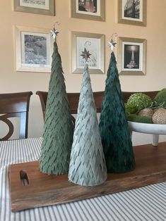 three christmas trees sitting on top of a wooden tray