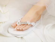 Wedding Lt Ivory Shoes,Bridal Flip Flops,Beach Wedding Shoes,Bridesmaid Slippers ,Floral Wedding Sandals, Rhinestone Flip Flops -SD047 We made with white flat flip flop decorated with Off white Flower .It is shining with a clear crystal on the lace. These flip flops are designed for brides and bridesmaids looking for style. Model shoe size US 8. Quantity:one order is 1 pair (2 pcs). Elegant Round Toe Beach Wedding Shoes, Elegant Round Toe Wedding Shoes For Beach Wedding, Elegant White Wedding Shoes For Beach Wedding, Elegant White Wedding Shoes For Beach, Elegant White Beach Wedding Shoes, Summer Bridal Accessories For Bridal Shower, Summer White Bridal Accessories For Bridal Shower, White Summer Bridal Accessories For Bridal Shower, White Bridal Accessories For Summer Bridal Shower