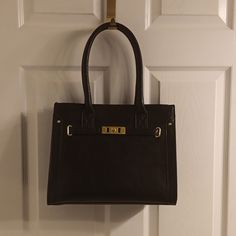 10 X 13 X 6 Black Handbag. Center Separated By Zipper Compartment. Inside Zipper On One Side And Two Pouches For Phone Etc. On The Other Side. Handbag Never Used. Black Satchel Tote With Hasp Closure, Black Tote Bag With Hasp Closure, Black Shoulder Bag With Hasp Closure For Shopping, Black Satchel With Hasp Closure For Shopping, Black Box Bag With Hasp Closure And Double Handle, Black Bags With Hasp Closure For Shopping, Black Bag With Hasp Closure For Shopping, Black Shoulder Bag With Metal Hardware, Black Box Bag With Hasp Closure For Shopping