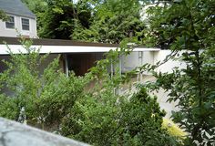 the house is surrounded by trees and bushes