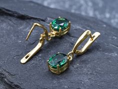 Gold Emerald Earrings set with a Created Emerald in a flawless diamond cut & clarity, deep green color, at 10x8mm, 6 Carats a pair. Dangling Earrings made of Gold Vermeil ☞ thickest 18k Gold Plating on Solid 925 Sterling Silver ☞ made to last. Click here for ☞ Matching RingClick here for ☞ Matching Pendant Details:♥ Created Emerald in a flawless clarity and deep green color,♥ Garnet: 10x8mm, 3 Ct, Diamond cut♥ Lever Back Closure - "English Lock"♥ Height 17mm, Width 8mm♥ 18k Gold VermeilSKU 2828( Gold Emerald Earrings, Deep Green Color, Earrings Emerald, Flawless Diamond, Drop Earrings Gold, Victorian Rings, Emerald Earrings, Green Earrings, Earrings Long